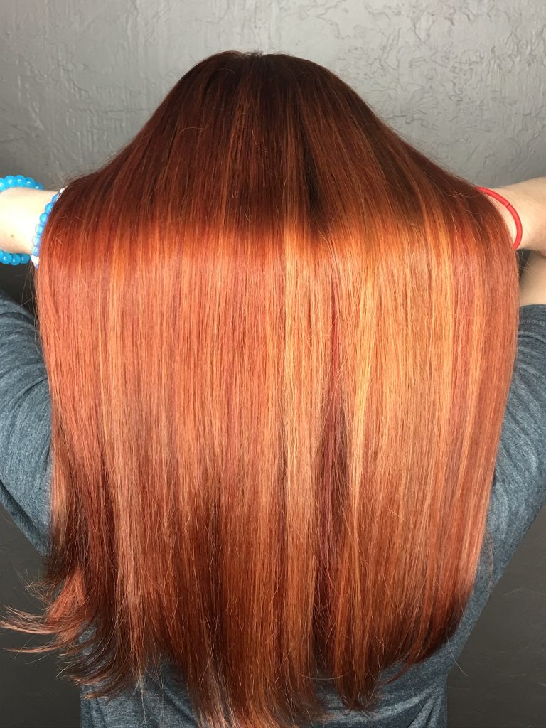 Copper hair with seamless extensions showing rich shine and smooth dimensional color.